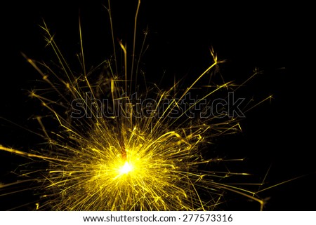 Bright yellow sparks from a sparkler