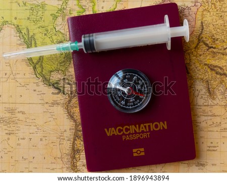 Vaccination Passports on map with compass and vaccine it self, covid-19 concept, selective focus.