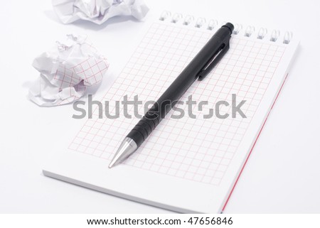 Isolated spiral notepad with clipping path. Pen on the note pad. Rumple paper around