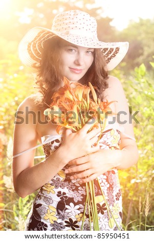Portrait of beautiful female with flowers in hands