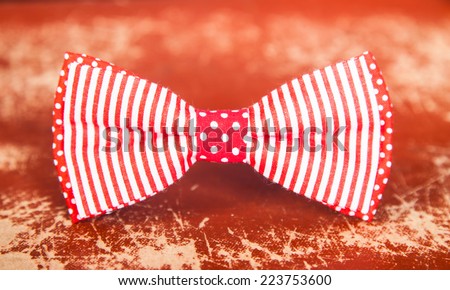 red bow tie with stripes and polka dots