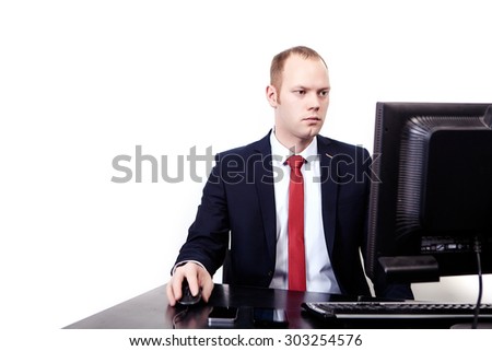 Businessman in a suit with a red tie sits on workplace computer. Phone, tablet, mouse, keyboard. Isolated on white background