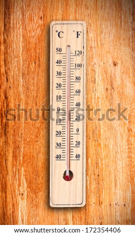 Thermometer on wood background