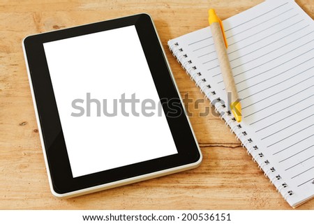 empty tablet pc and notebook with pen on the office desk