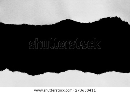 Torn pieces of paper on black background