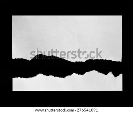 Torn pieces of paper on black background, space for advertising copy