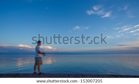 Fishermen at sunrise on the sea pier