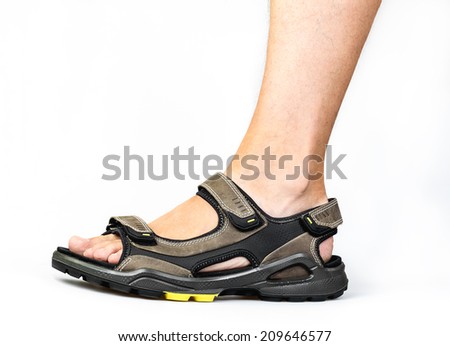 Men\'s foot in sandals on a white background
