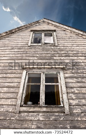 Old haunted house with two dark windows