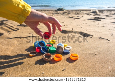 Similar – Foto Bild Am Strand gesammelte Plastikpfropfen.