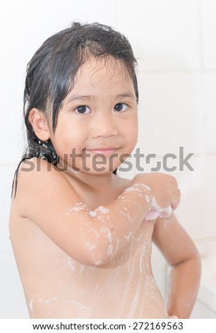 Portrait of cute girl happy  washing her body