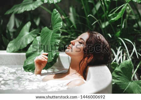 Similar – Image, Stock Photo Young woman in bathtub with balloons after party