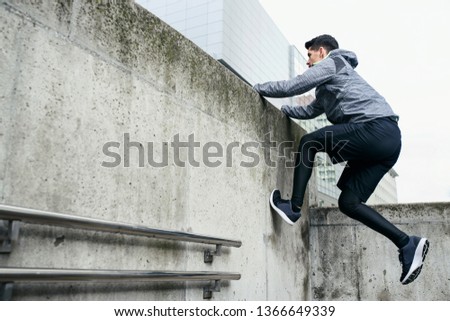 Similar – Image, Stock Photo Anonymous sportsman jumping on trial bike during workout