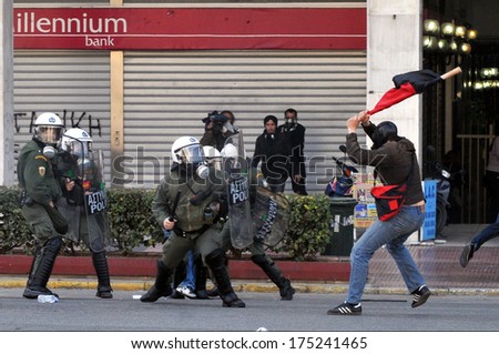 ATHENS, GREECE-March 11 Riot police under attack from rioter, during demonstration, in central Athens, March 11, 2010.