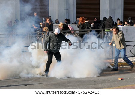 ATHENS, GREECE- DEC. 12 Protesters trying to avoid tear gas canister, during demonstration, in the centre of Athens,, in Athens, December 10, 2008.