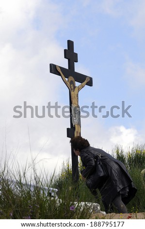 GREECE, Athens, April 18, 2014. A worshipper kisses  the image of the crucified Jesus, during the ceremony of Good Friday before Easter, in the monastery of Penteli, north of Athens