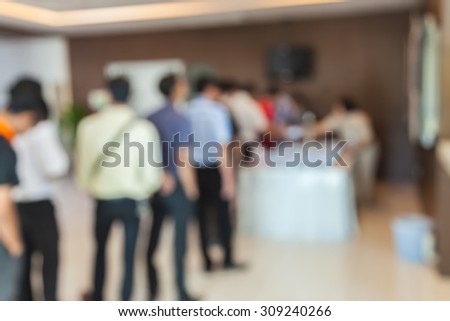 Abstract blurred people lined up to get a snack in the conference business