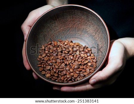 coffee beans in ceramic ware are holding