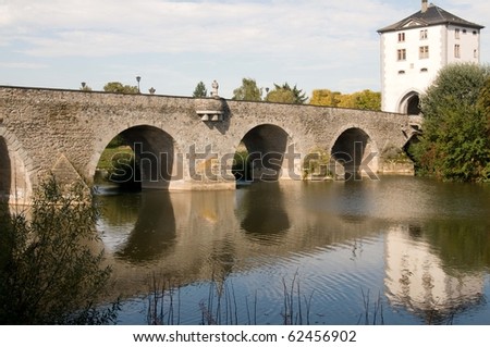 The ancient bridge across the river and reflection.