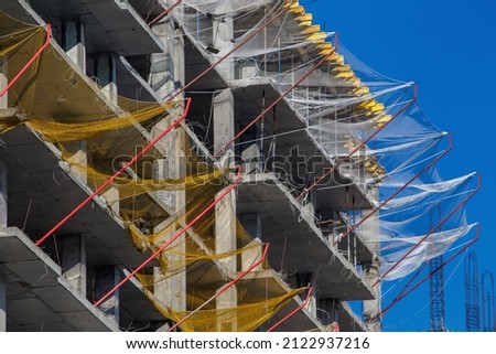 Similar – Image, Stock Photo Scaffolding with protective net and tarpaulin from frog perspective / house renovation