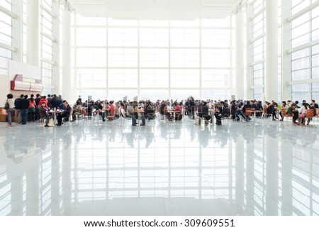 BEIJING, CHINA - MARCH 26, 2012: Visitors have lunch in the bright and high dining area of China International Exhibition Center in Beijing,China on March 26, 2012.