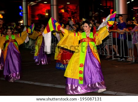 SYDNEY, AUSTRALIA - FEBRUARY 2, 2014: Dancers in a city centre parade celebrate Chinese New Year . Organisers estimate that 100,000 people lined the route to welcome in the year of the horse.