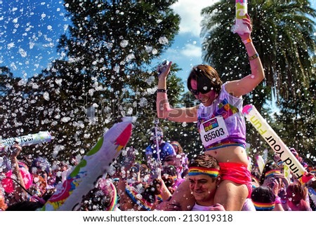 SYDNEY,AUSTRALIA - AUGUST 24,2014: Competitors in the 'Color Run' fun run in Centennial Park. Runners are doused in coloured powder, bubbles and water as they run the 5K course.