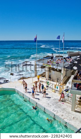 BONDI,AUSTRALIA - NOVEMBER 2,2014: People enjoying swimming and yoga at Icebergs Swimming Club. Open since 1929, it is popular with celebrities.