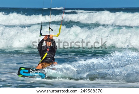 NEWCASTLE,AUSTRALIA - JANUARY 24,2015: A kite surfer enjoys the waves off Nobby\'s Beach. Newcastle is the 2nd city of New South Wales, after Sydney.
