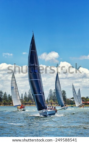 NEWCASTLE,AUSTRALIA - JANUARY 24,2015: Members of a local sailing club race their boats on the harbour. Newcastle is the 2nd city of New South Wales, after Sydney.