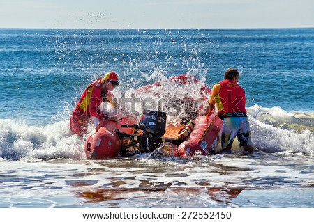 COLLAROY,AUSTRALIA - APRIL 25,2015: Surf lifesavers guide their craft through the breakers to reach the open ocean.