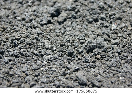 Grey background texture sand and stones from lava