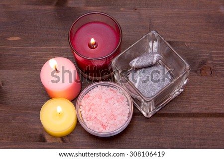 Candles and bath salts on wooden table seen from above