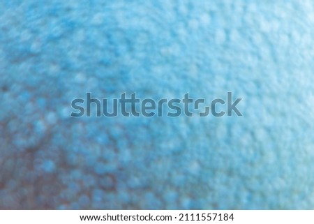 abstract background: defocused shot with bokeh effect transparent surface with moisture drops, toning 