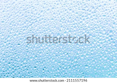 refreshing background: imitation of dew on a transparent surface, color toning, short focus. 