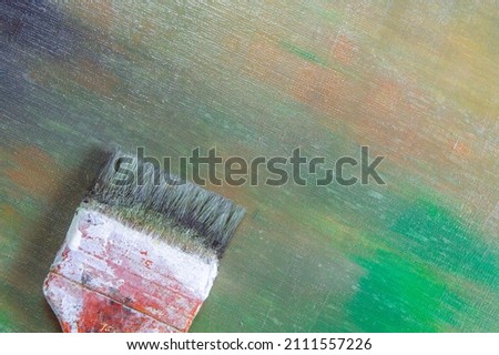 abstract colored creative background - rough linen canvas unevenly covered with multi-colored primers, reflections of light, wide brush. Toning, blur. Temporary object. 