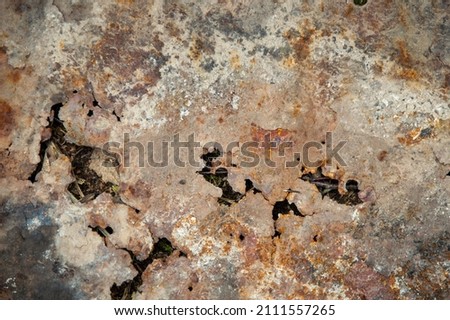 grunge background: rust on an old painted metal surface, holes from through corrosion of steel, toning 