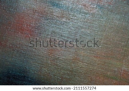abstract colored creative background - rough linen canvas unevenly covered with multi-colored primers, reflections of light. Toning, blurring, selective focus. Temporary object. 