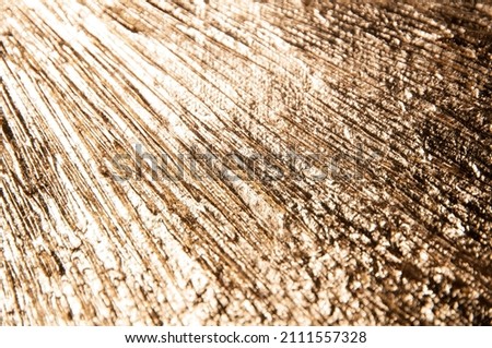 area of radially crumpled gold patina, flare effect, short focus 