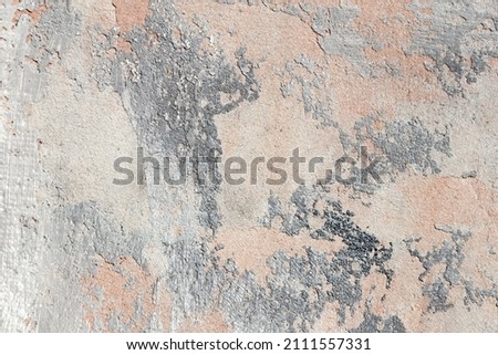 surface covered with decorative plaster with a chaotic pattern, multi-colored spots 