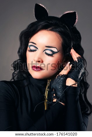 Portrait of beautiful young european model in cat make-up and costume
