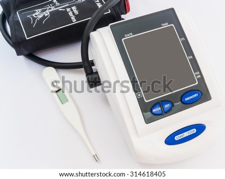 Digital Blood Pressure Monitor and thermometer on white background, primary healthy check