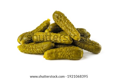 Pile of pickled gherkins isolated on a white background. Whole green cornichons marinated with dill, garlic and mustard seeds. Crunchy baby pickles. Tasty canned vegetables. Front view.