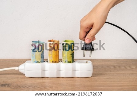 Similar – Image, Stock Photo Socket and euro bills placed in the shape of a circle. Concept of saving electricity at home. Euro banknotes. Electricity costs and expensive energy concept