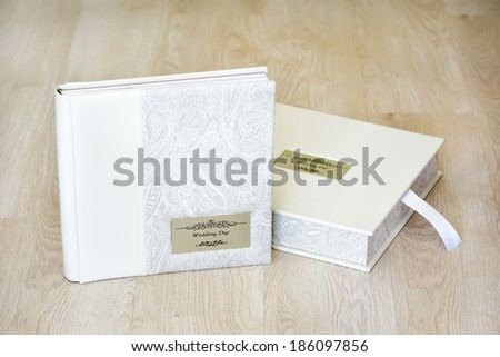 Wedding photo album and box for it with combined ivory leather cover and metal shield with title \