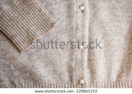 Angora wool cardigan with pearl button. Selective focus.