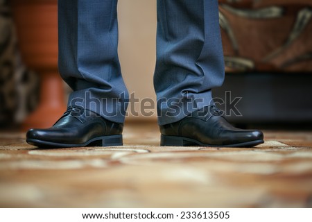 Close up of feet of the man in a suit and shoes