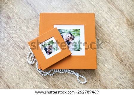 Wedding photo book and CD box with orange leather cover and passe-partout