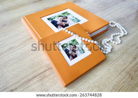Wedding photo book and CD box with orange leather cover and passe-partout