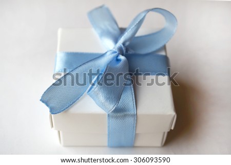 White box with blue tape
